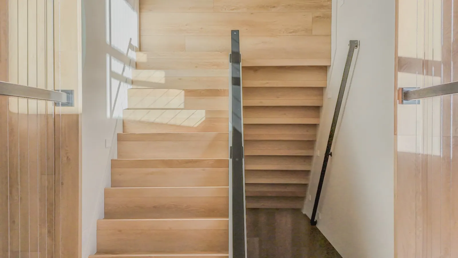 Switchback white oak staircase with steel railing