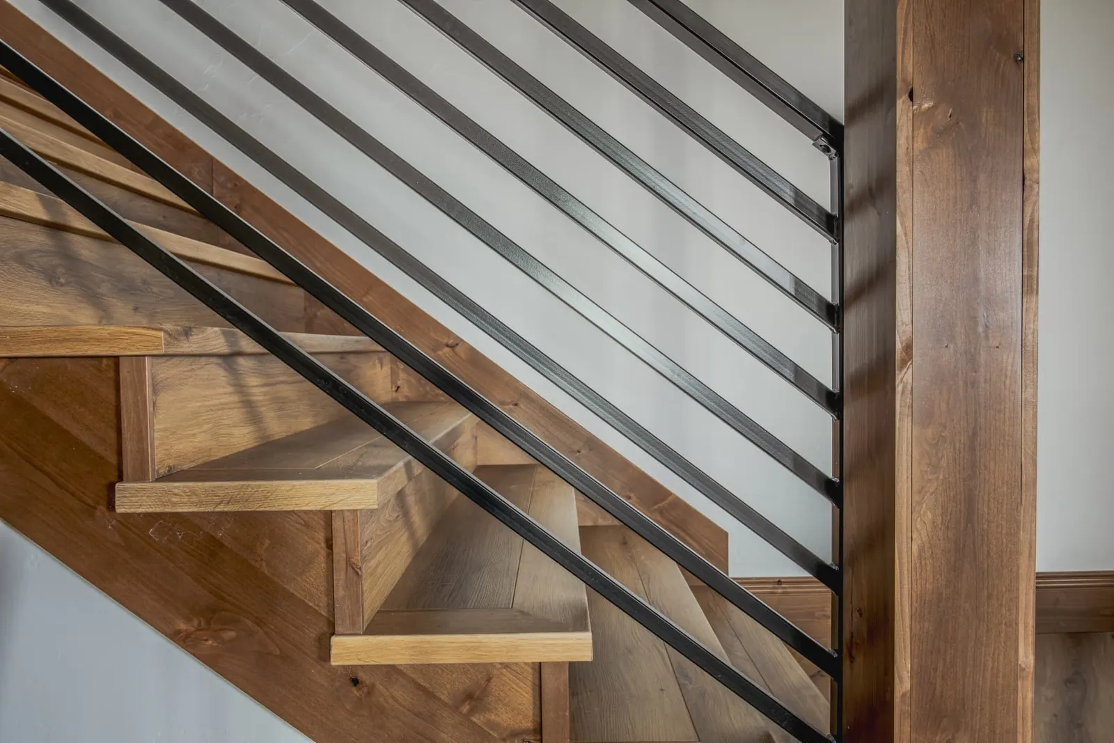 Open-riser stair detail with wood treads and steel railing