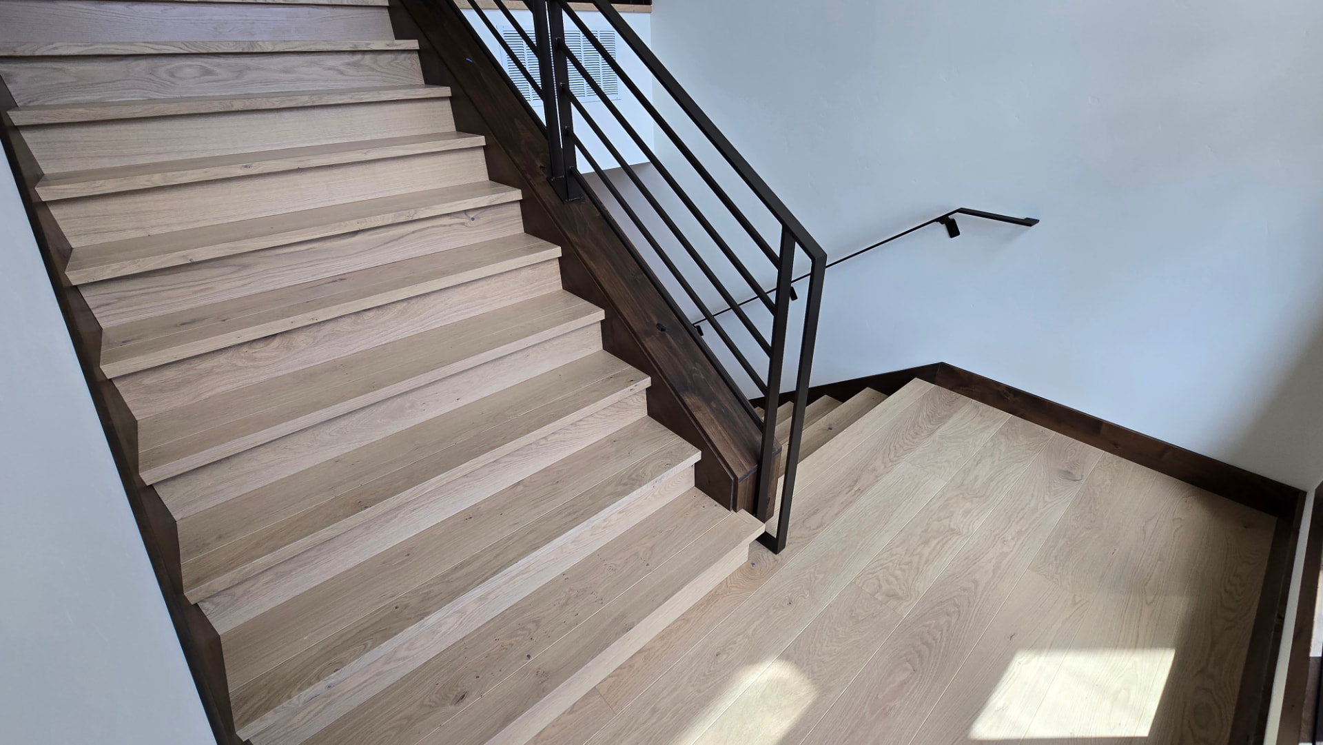 Overhead view of oak stair treads turning at a landing