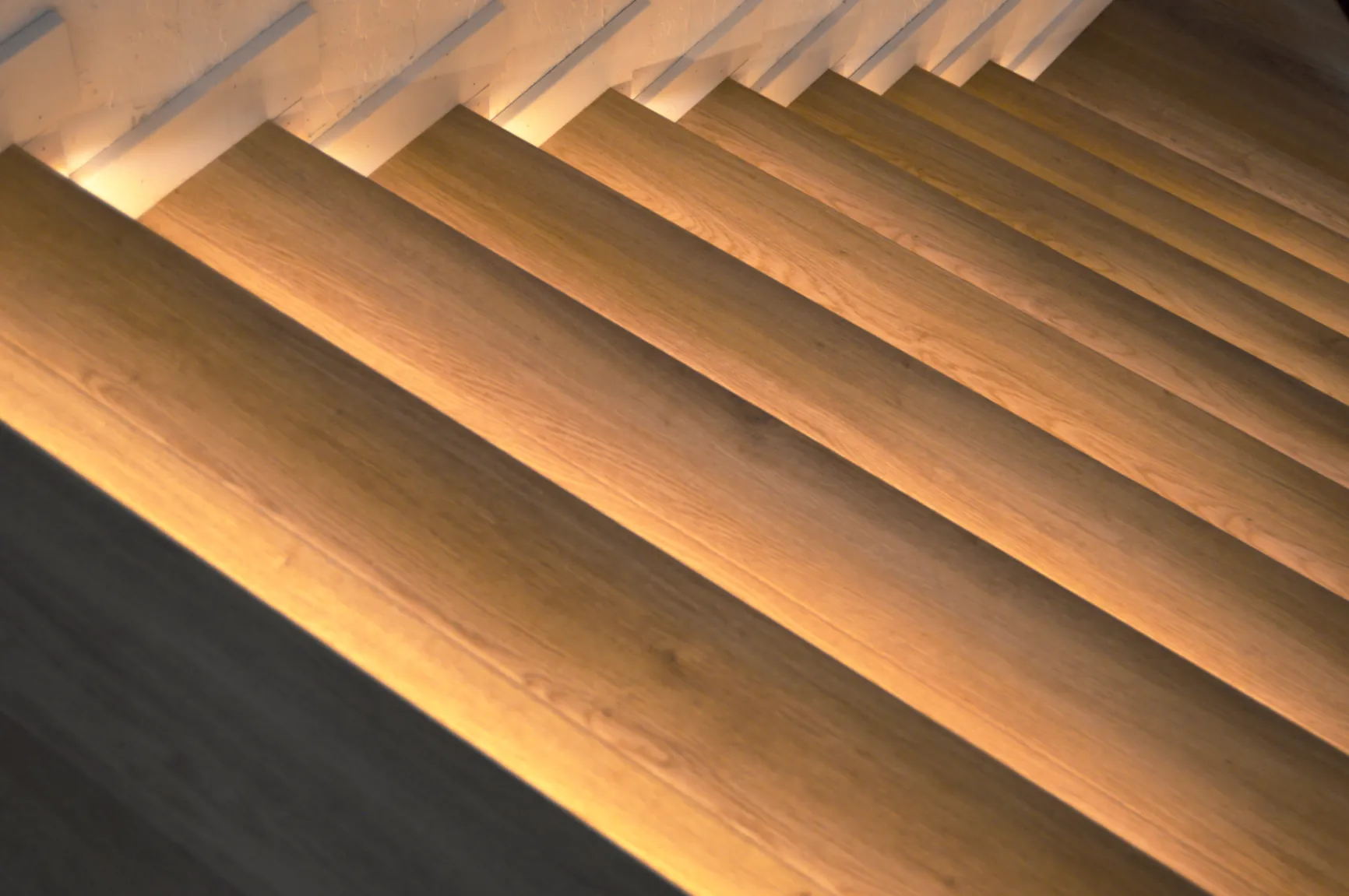 Angled close-up of backlit oak stair treads